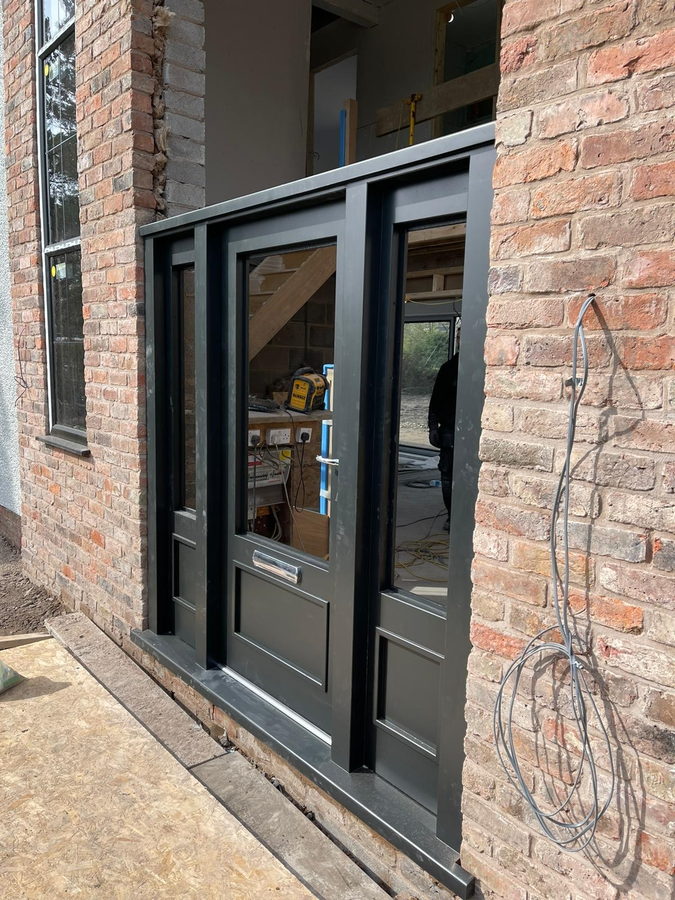 The finished doors and sidelights in the brick opening