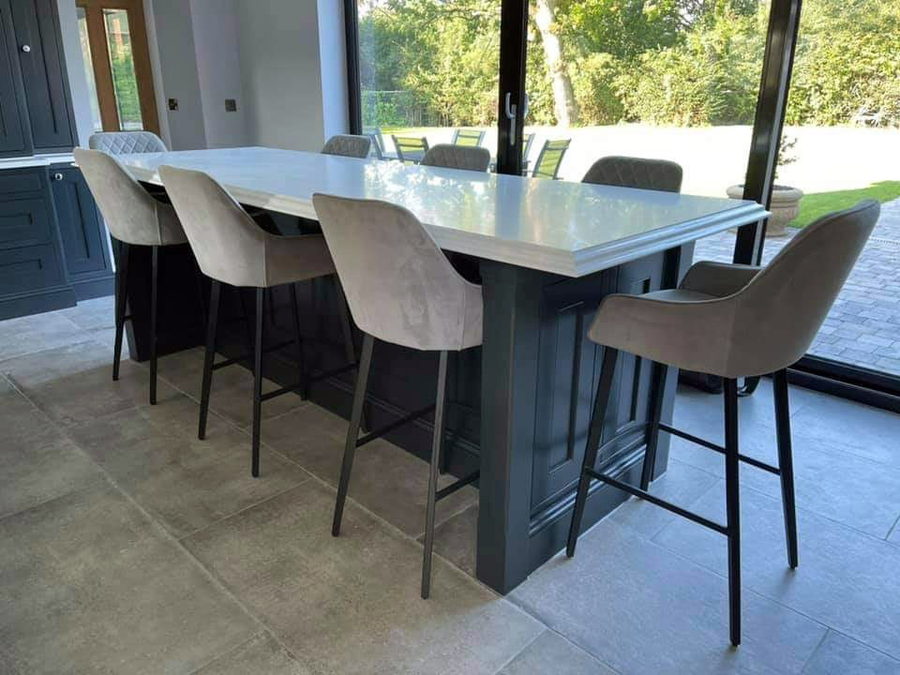 A quartz breakfast table seating six, off the same kitchen