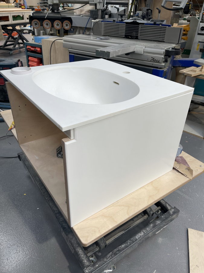 A wall-hung vanity with an integrated basin top, in the workshop