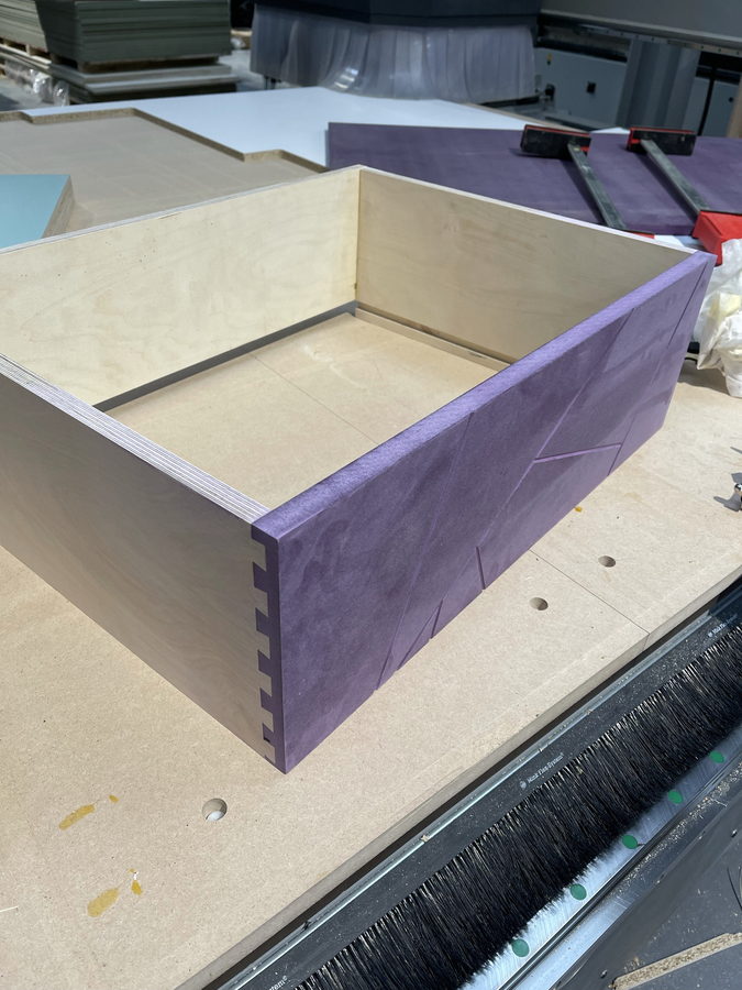 Machine-cut comb joints in a plywood and coloured-board drawer box