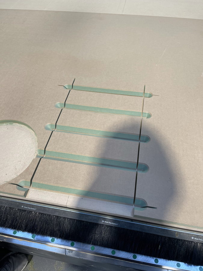 Slotted battens laid out as a cross frame, halvings cut on the CNC