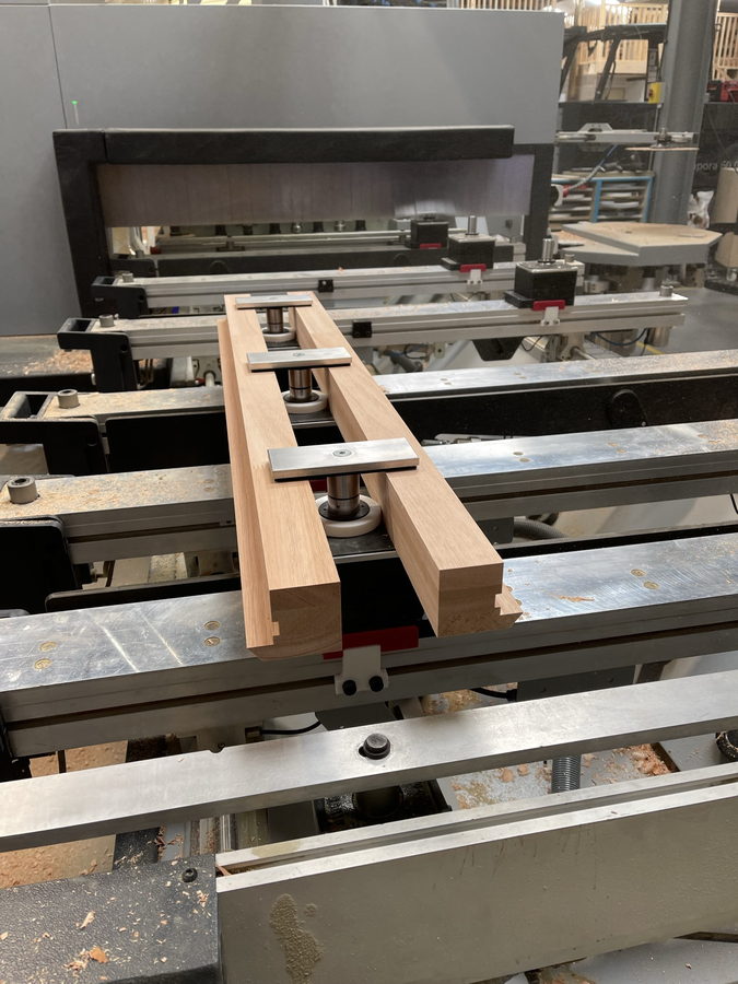 Oak battens held on the pod-and-rail bed by pneumatic clamps