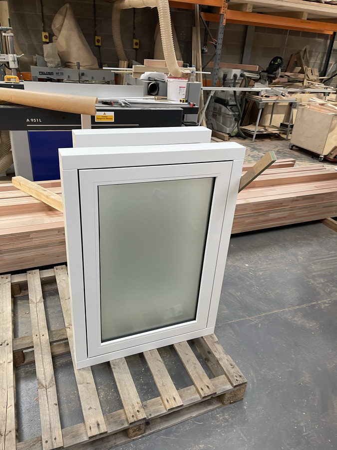 A painted casement window on the pallet, ready to go