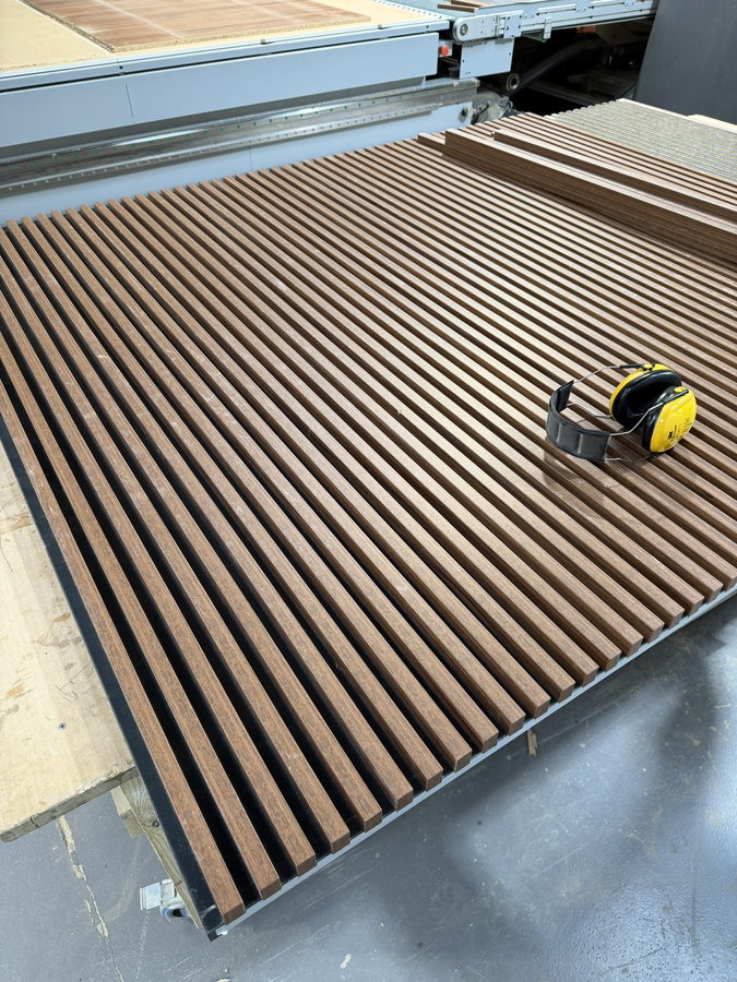 A walnut slat panel run machined in one go