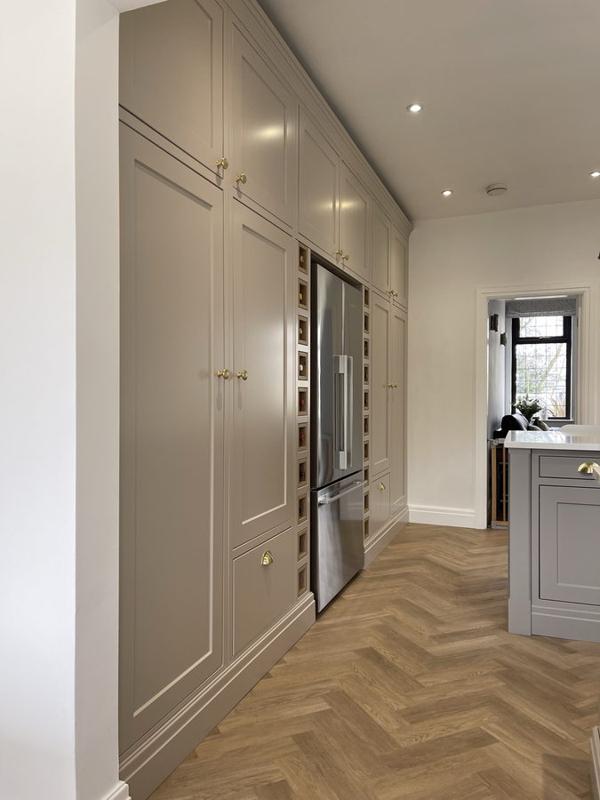 Floor-to-ceiling larders and an integrated fridge over herringbone parquet