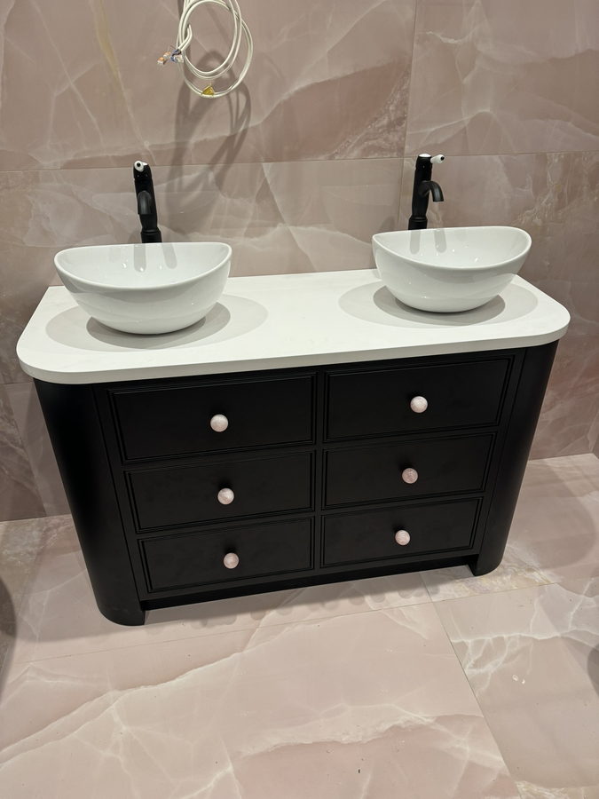 A curved-end double vanity with six drawers and two counter basins