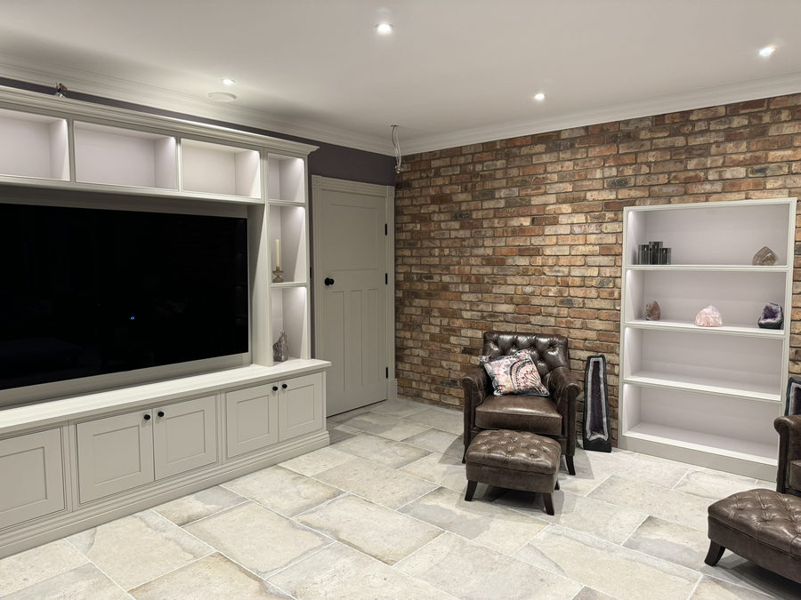 Media wall and fitted alcove bookcase in the same snug