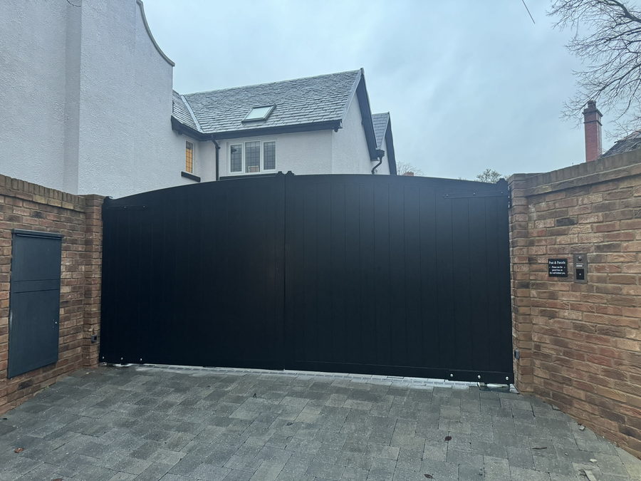 Arched-top timber driveway gates in Tricoya with an Accoya top rail
