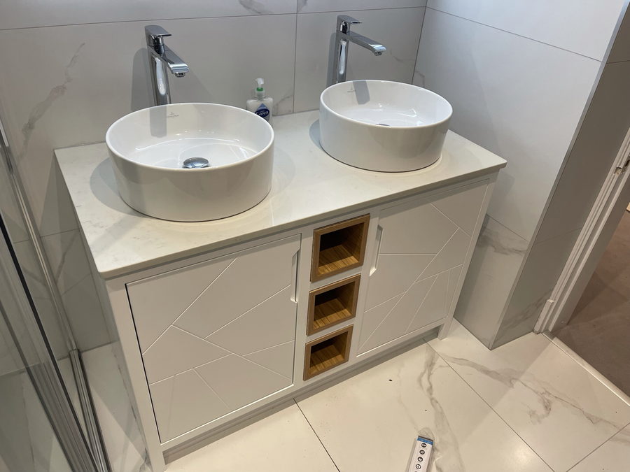 The vanity in the room, with marble-effect tiling