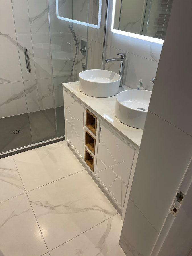 A backlit LED mirror over the twin basins