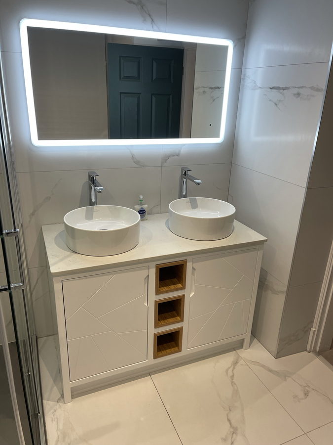 The twin-basin vanity straight on, under its mirror