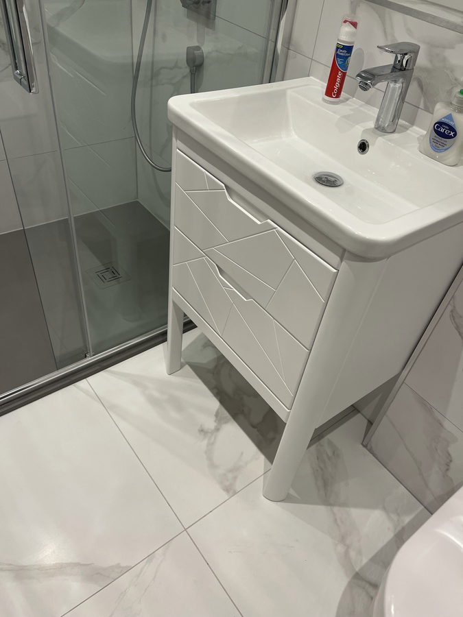A white gloss vanity with chamfered drawer fronts