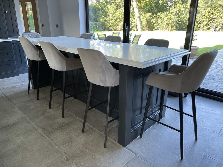 A long breakfast bar seating six, beside the garden doors