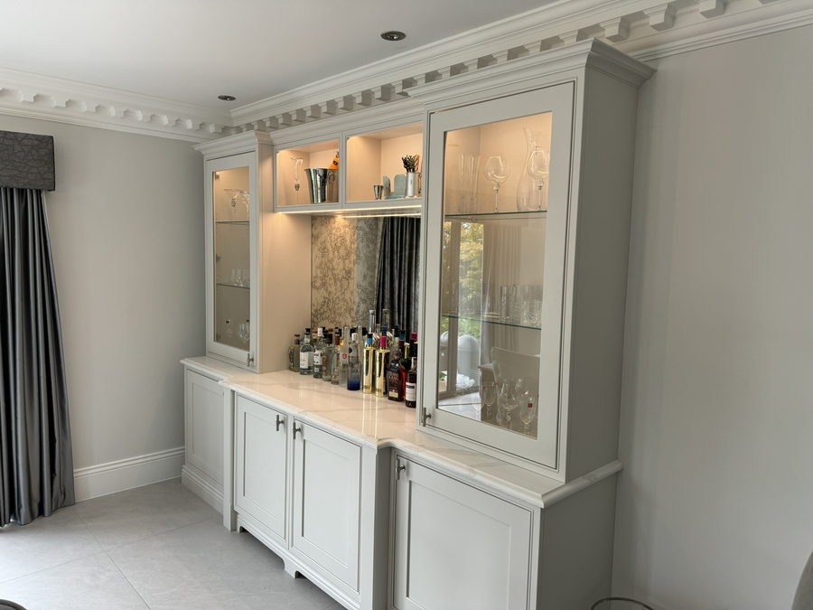 The glazed dresser cabinets lit for the evening