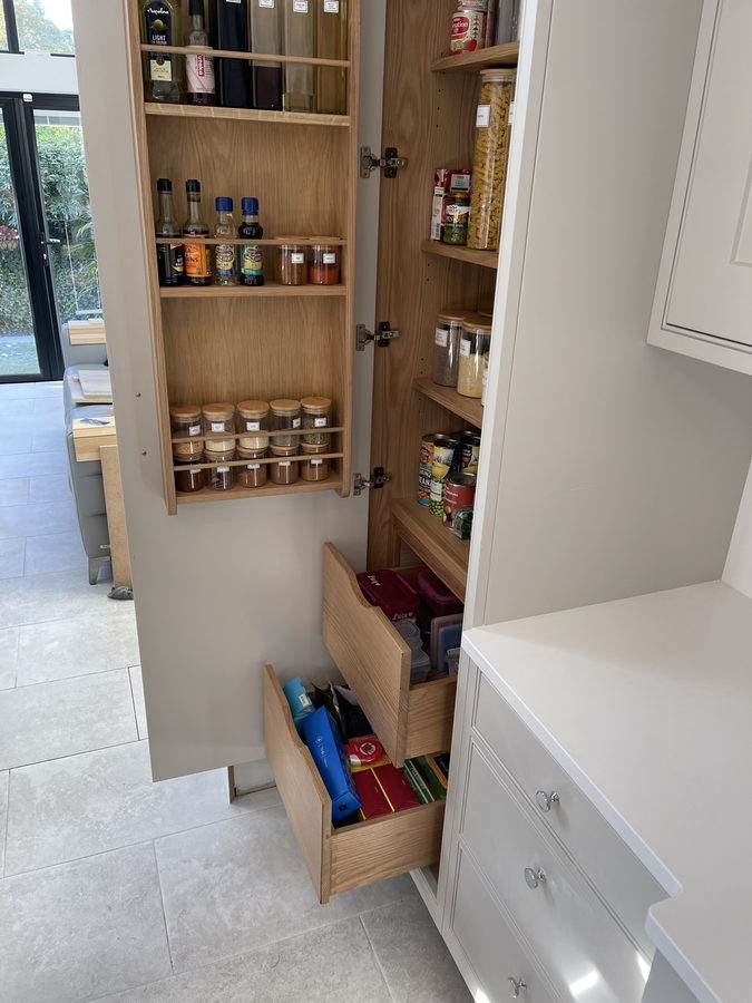 An oak-lined pull-out drawer inside the same larder
