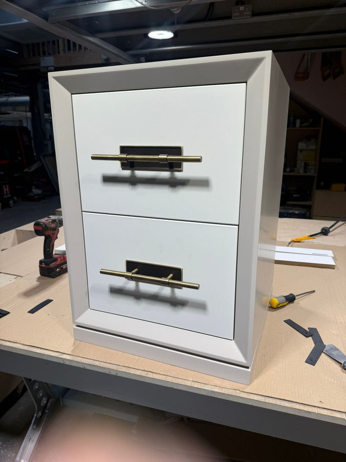 A gloss drawer unit on the bench with the handles going on