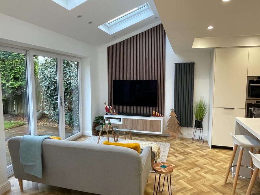 A slatted timber feature wall behind a floating media unit