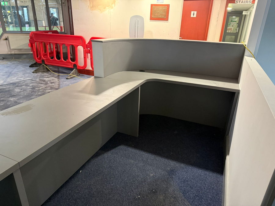 A reception desk installed while the fit-out carried on around it