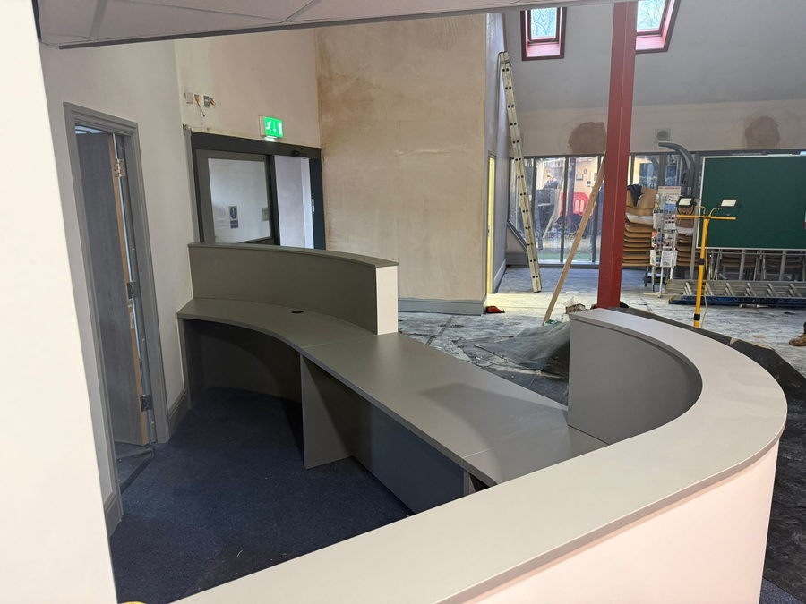 The desk being built on site between the steel columns