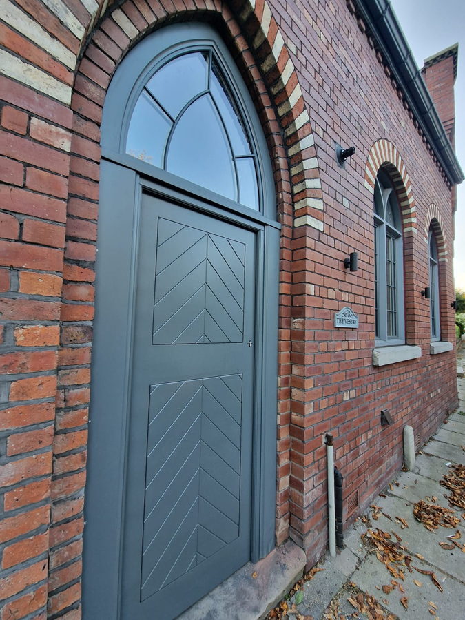 The arched frame and chevron boarding, seen along the wall