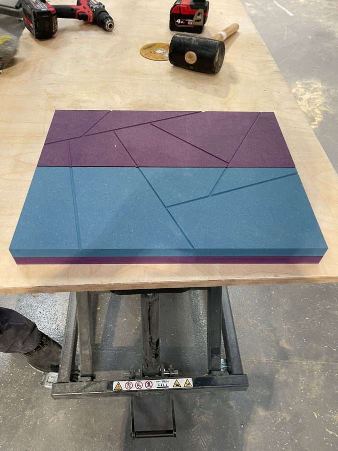 A faceted panel machined in coloured board