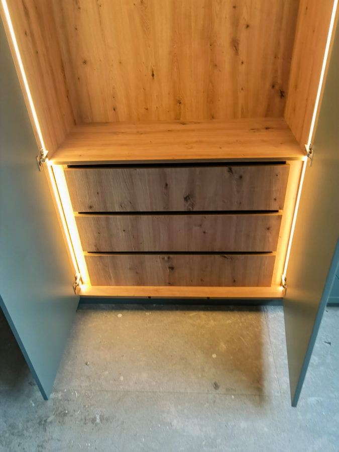 An oak-lined interior with LED strips and soft-close drawers