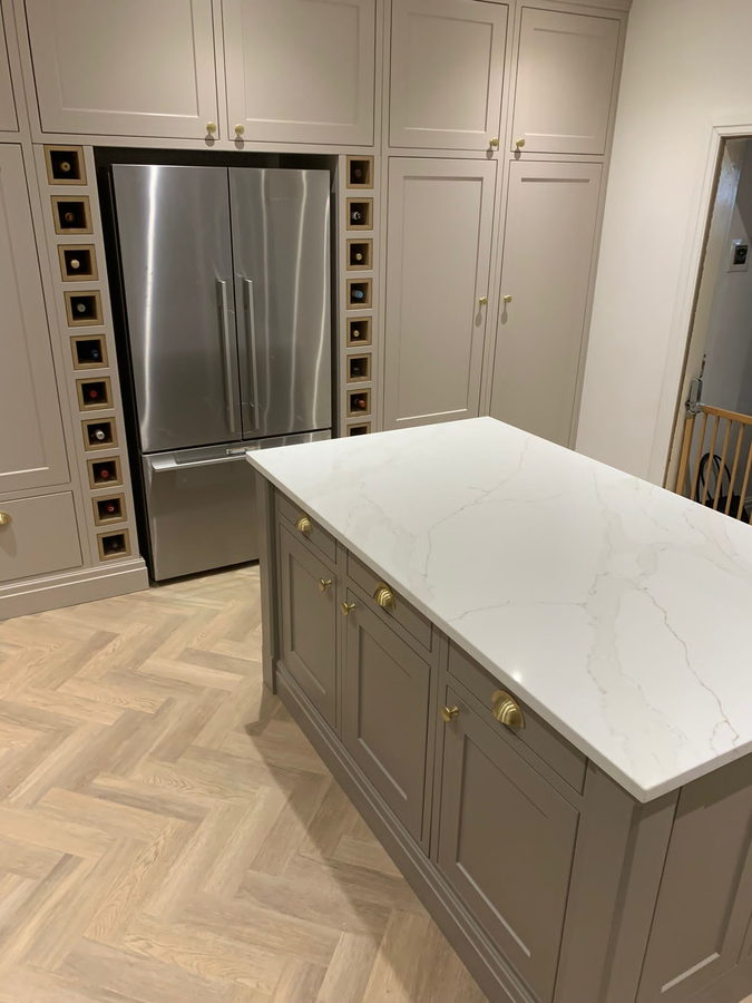 The American fridge framed by two full-height columns of wine cubbies