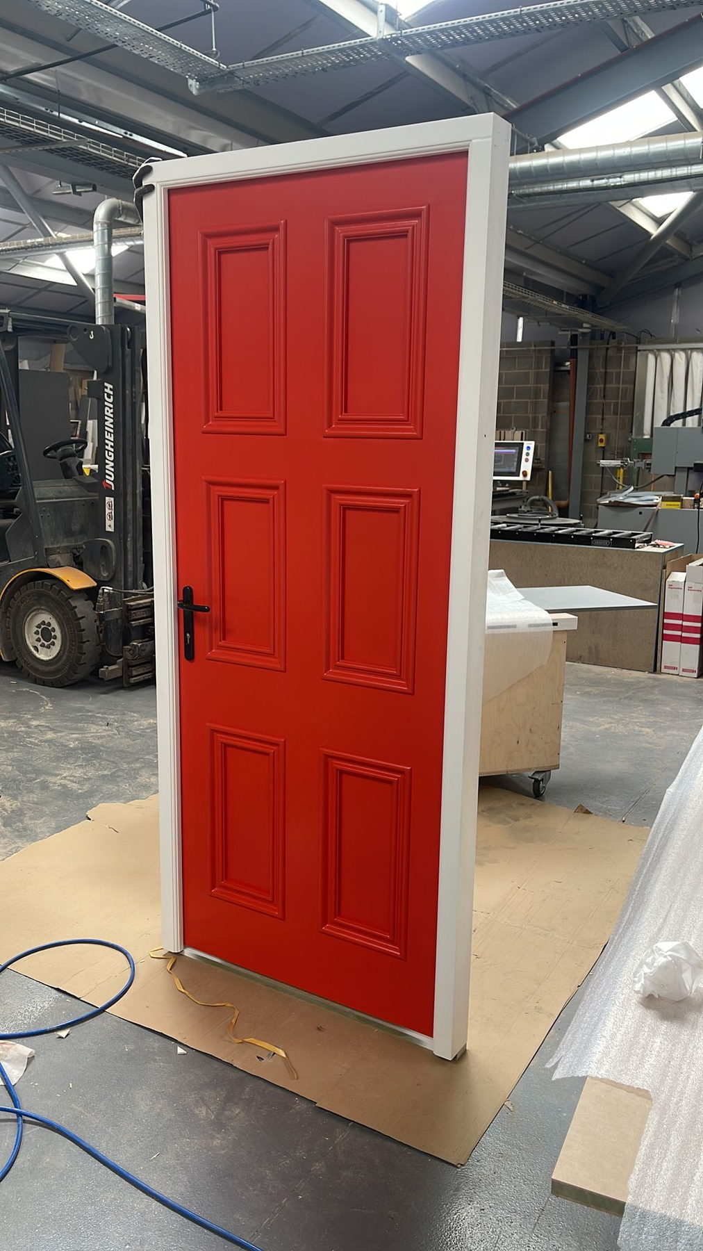 A bright red door, sprayed to the customer's own colour