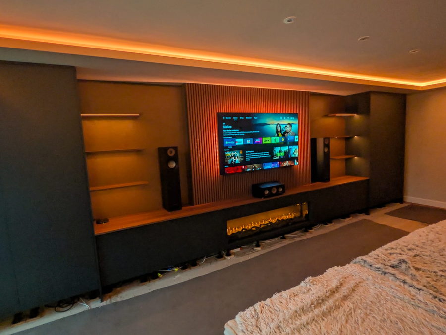A bedroom version: floating shelves, cove lighting and integrated speakers