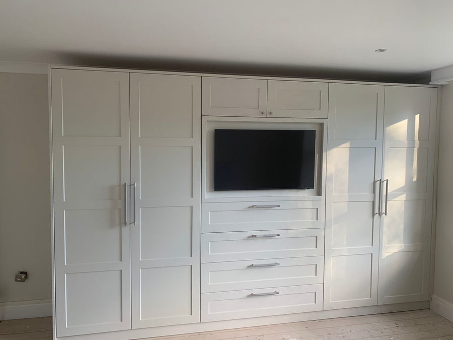 The same shaker pattern in another bedroom, with morning light across the doors