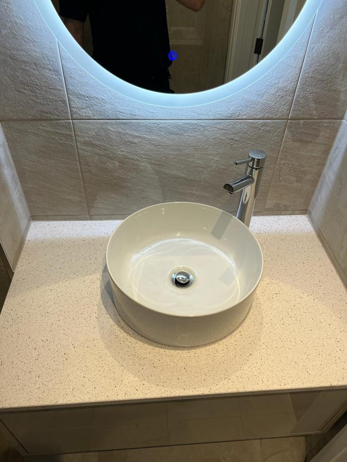 A round counter basin on a speckled quartz top
