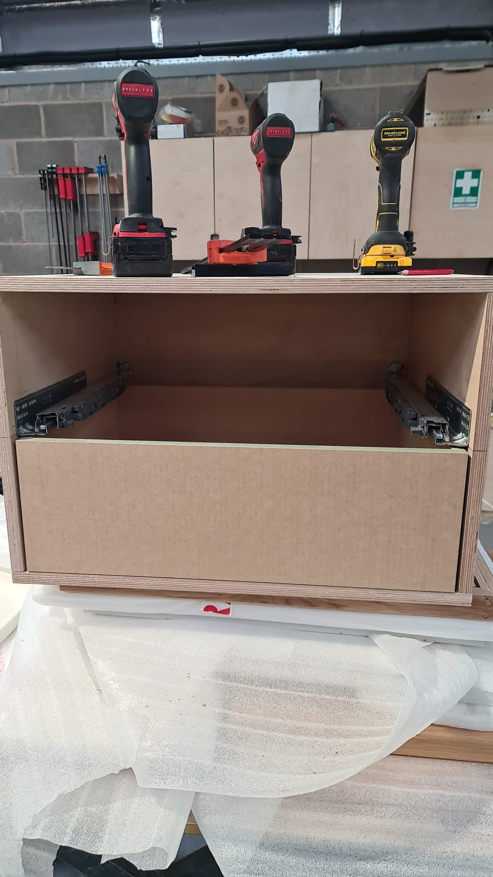 Drawer boxes on soft-close runners, set out on the bench