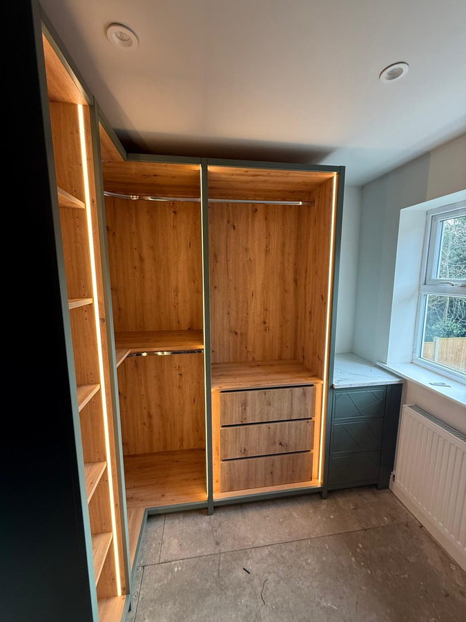 Rustic oak interiors with LED-lit shelving and a drawer bank