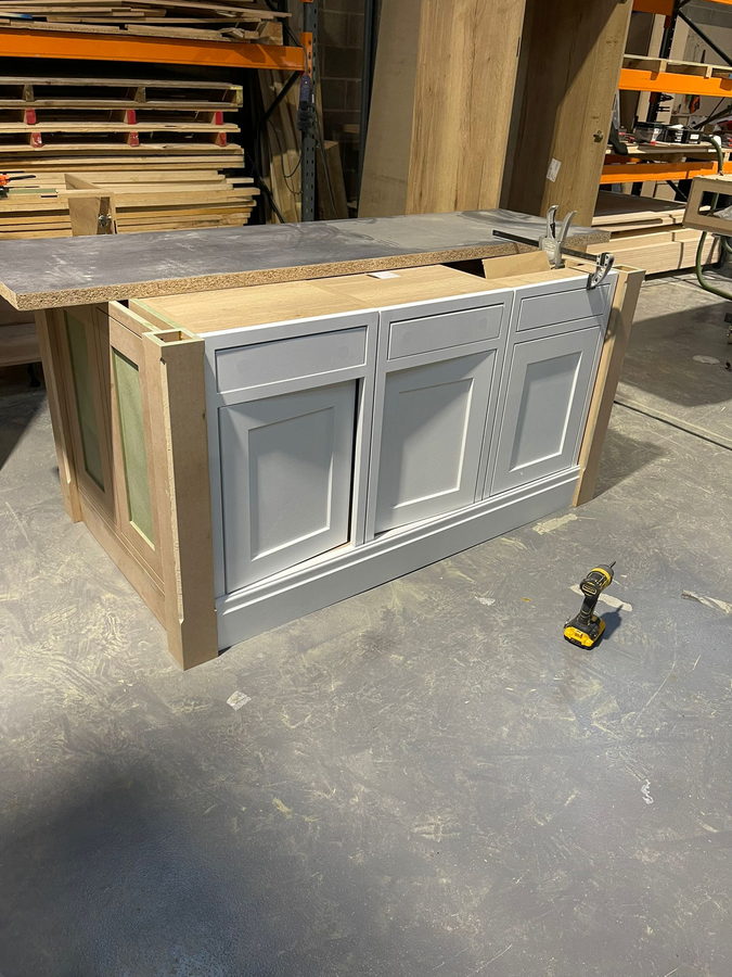 A shaker island carcass going together on the workshop floor