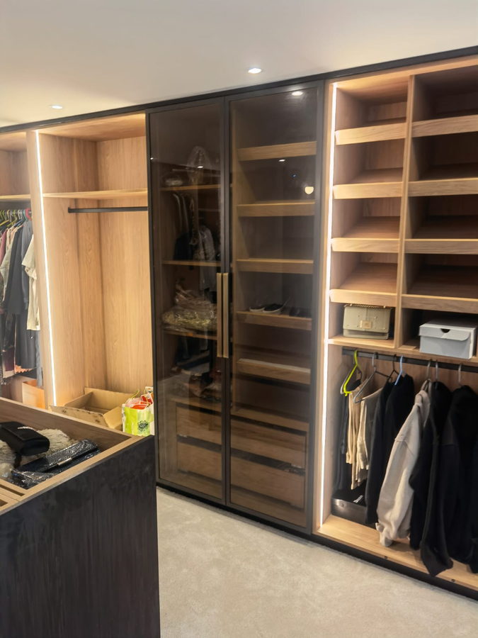 Bronze glass doors in black frames, closing off the dressing room