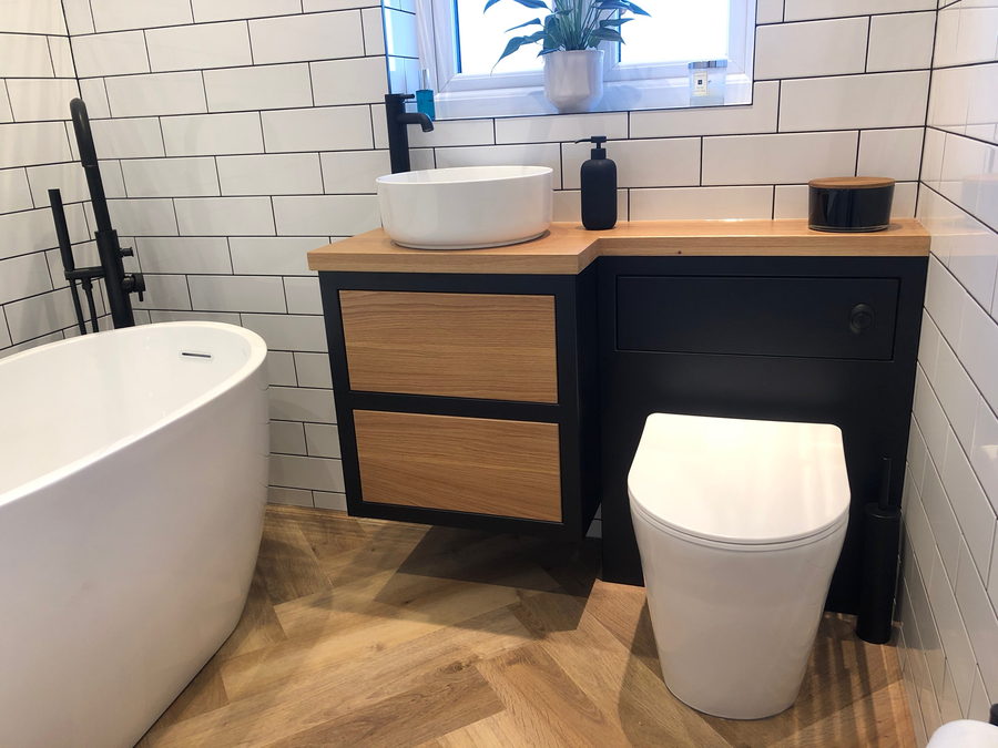 Black cabinetry with oak drawer fronts and a solid oak top