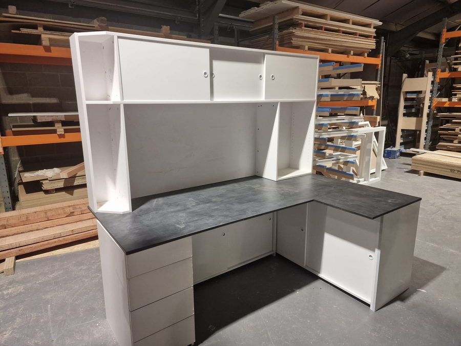 An L-shaped desk run with hutch shelving, assembled before delivery