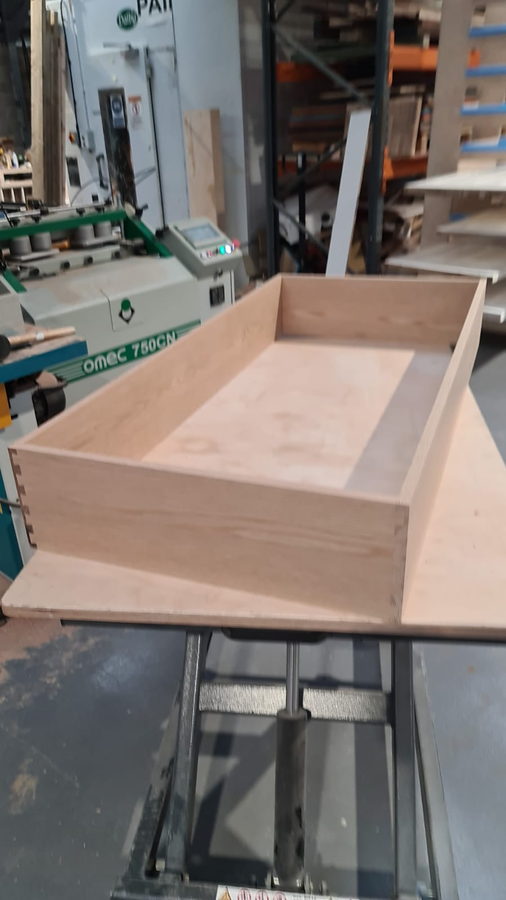 A large drawer box on the machine bed