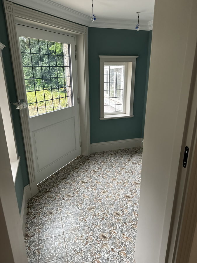 Painted panelling and window seats in a teal room